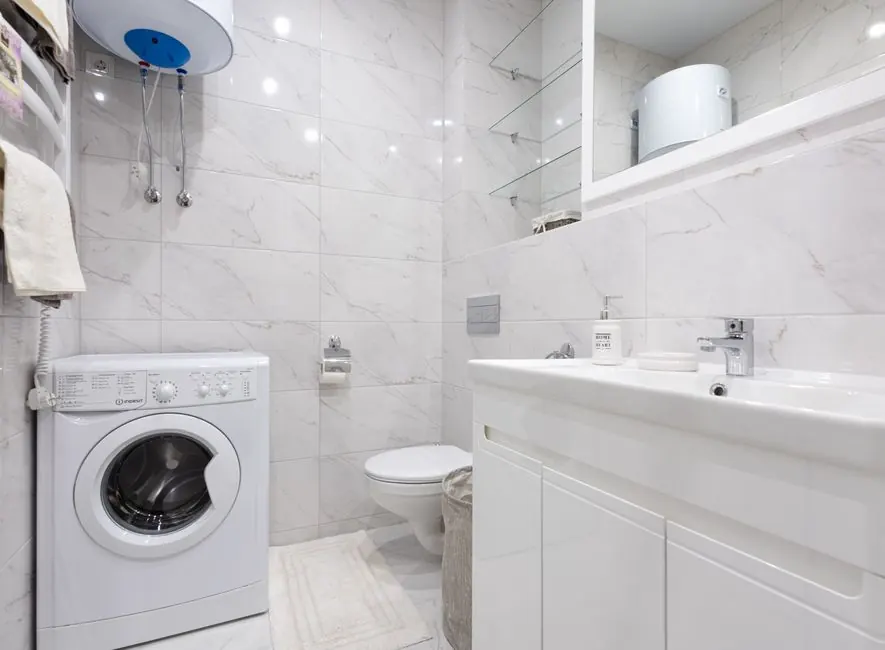 Wall-mounted tank water heater in a home