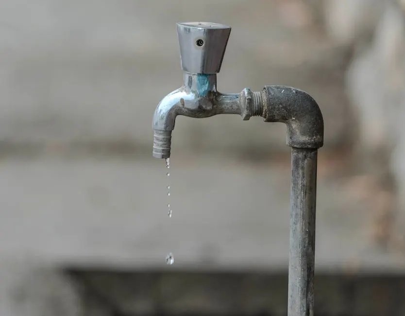 Close-up of water flowing from a tap during a water heater inspection in Lawrenceville, GA