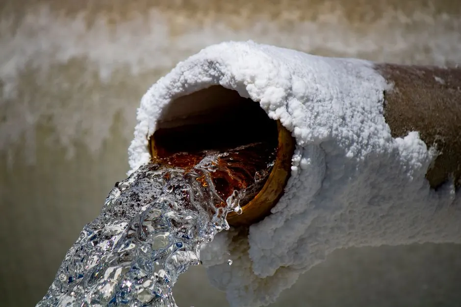 Rusty water flowing from a corroded pipe — a sign replacement beats repair