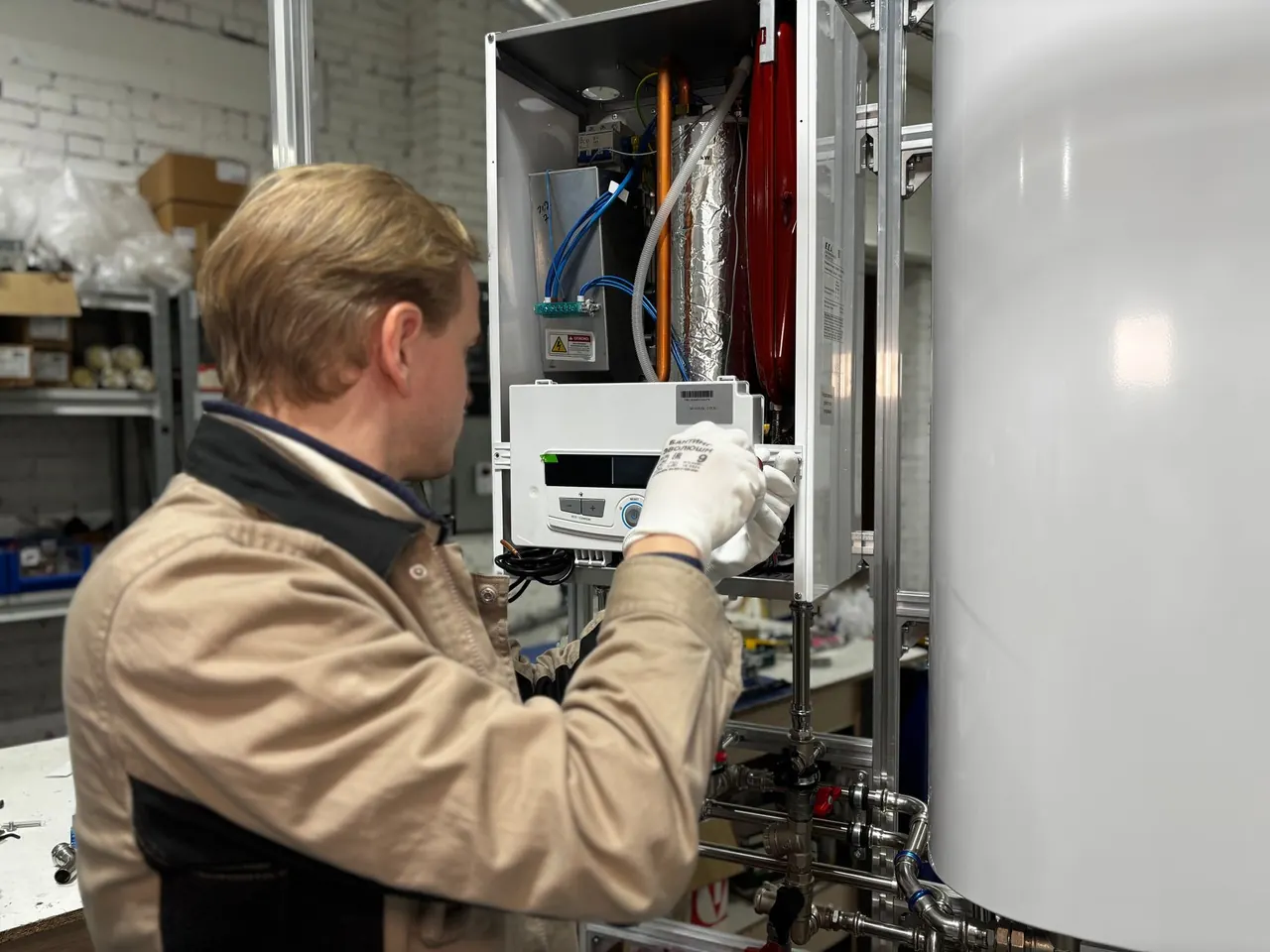 Technician diagnosing the internal components of a water heater during a troubleshooting visit in Lawrenceville, GA
